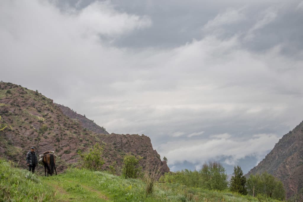 Horsemen descending towards the village.