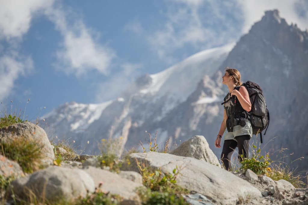 A female tourist climbing to Racek Camp in Kyrgyzstan