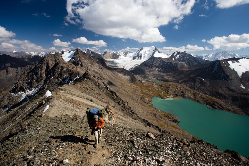 Hiker atop the Ala-Kol Pass on the Ak Suu Transverse Hike