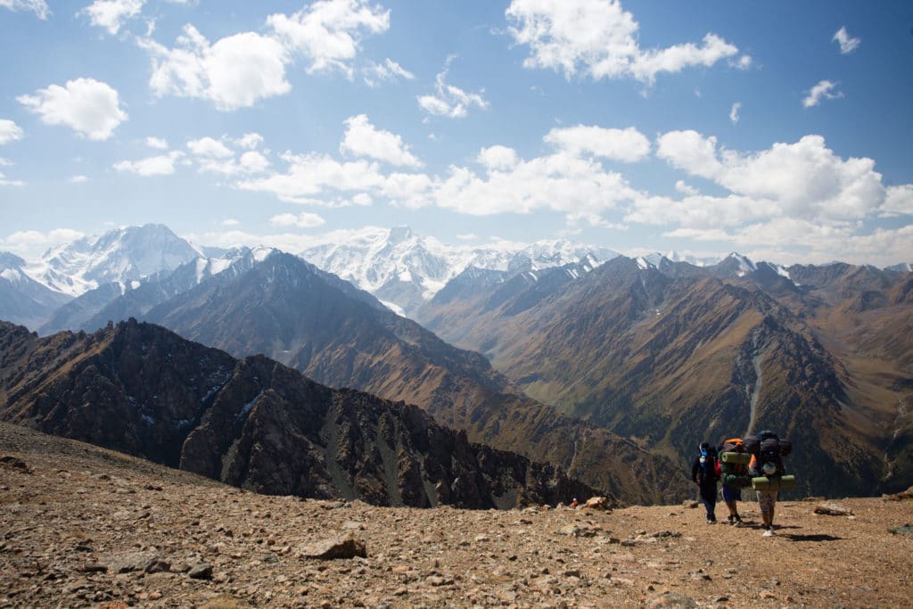 Trekkers descending from Ala Kol Panorama Pass to Karakol Valley