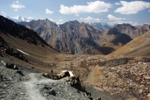 Solo hiker descending from Telety Pass to Jeti Oguz Valley