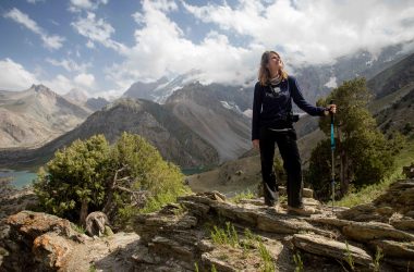 A foreign hiker stops to enjoy the view as she descends to the Kulikalon Lakes in the Fann Mountains of Tajikistan.