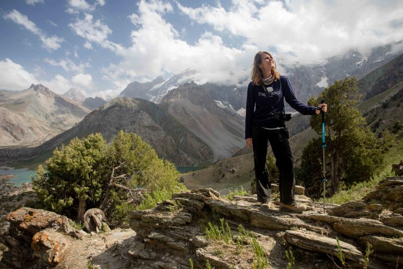 A foreign hiker stops to enjoy the view as she descends to the Kulikalon Lakes in the Fann Mountains of Tajikistan.