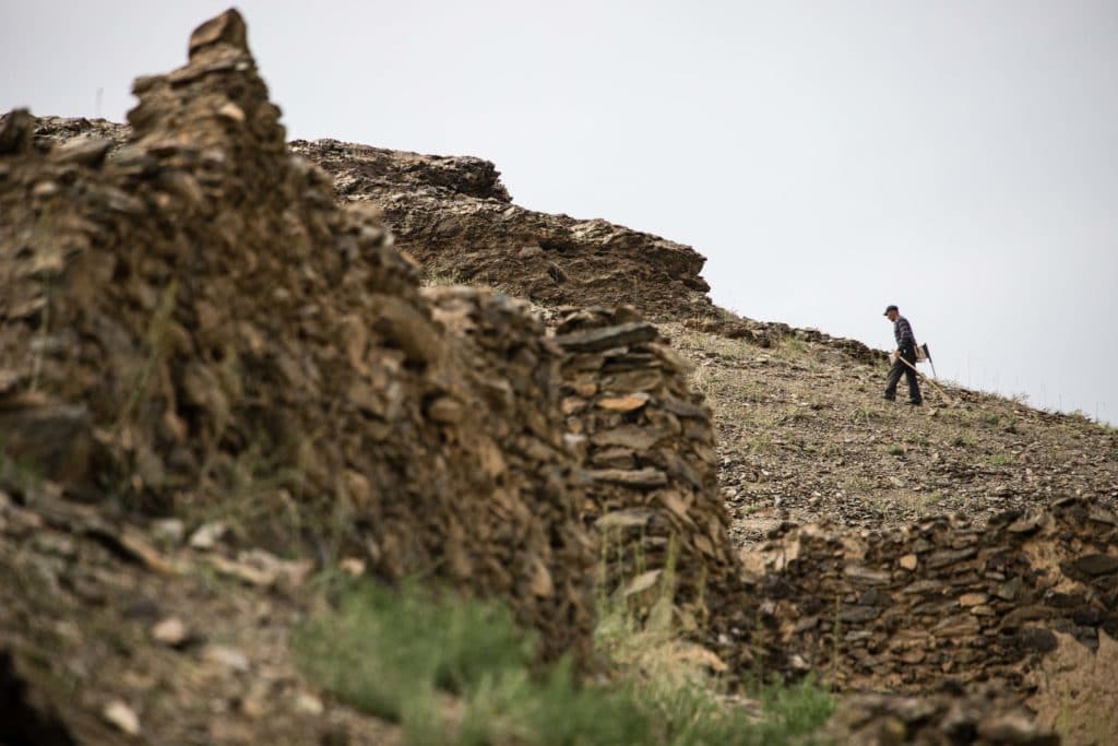 Local man walking in the ruins above Sentob Village