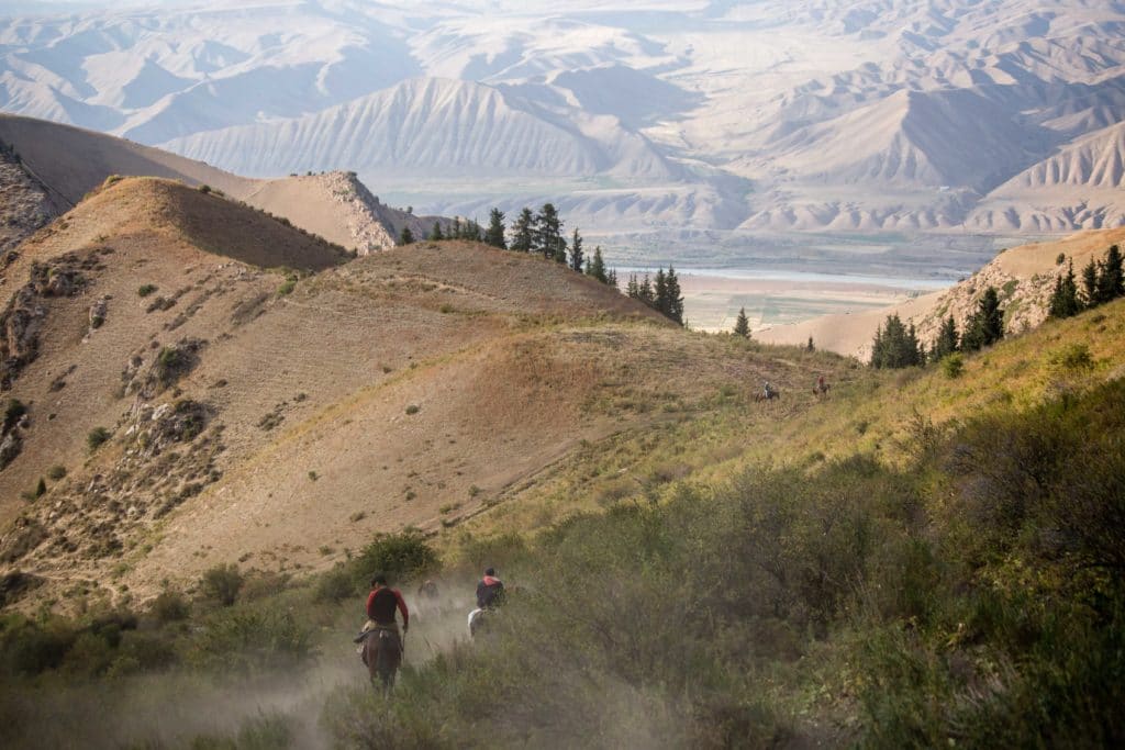 Horsemen descending from Ak Tash in Naryn Kyrgyzstan