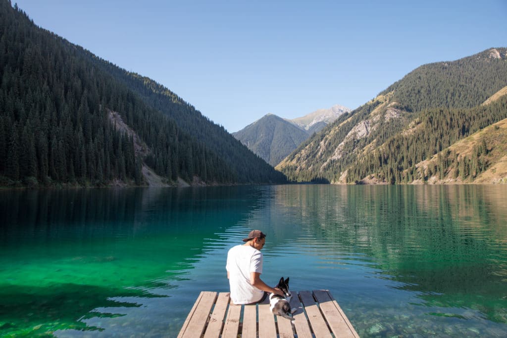 Tourists admiring the view of Kolsai Lakes National Park in Kazakhstan