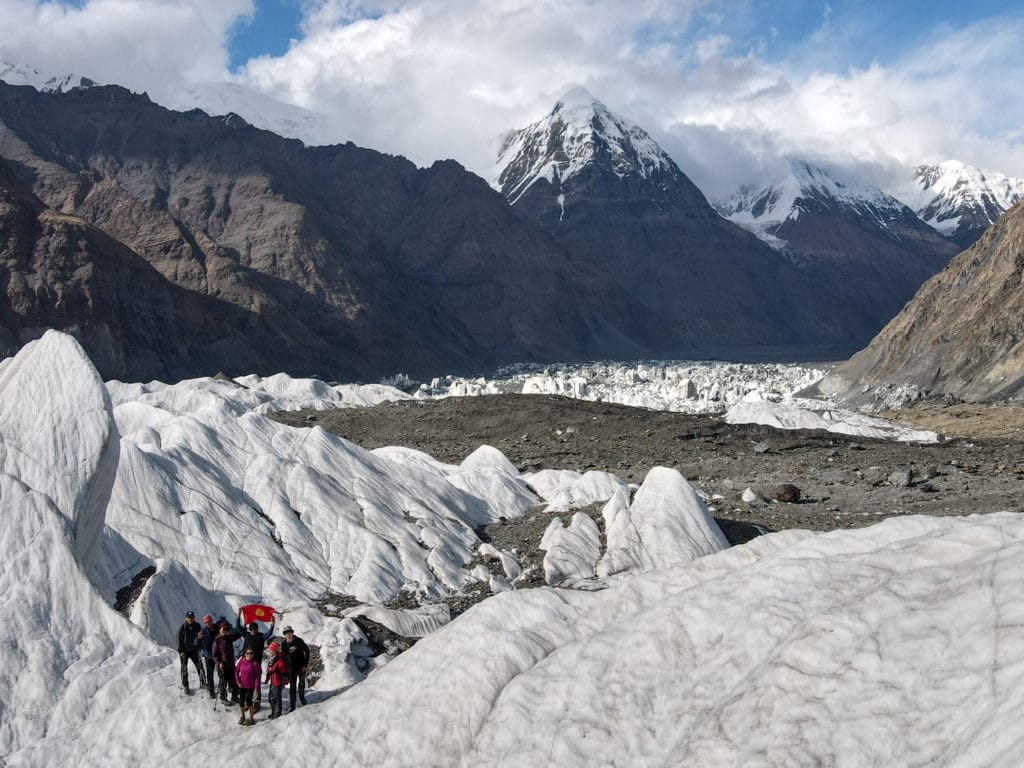 Hikers atop the Ice Wall near Merzbacher Lake