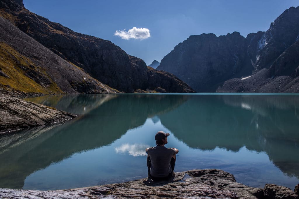 Tourist resting on the shore of Alakol Lake